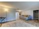 Living room with a large sectional sofa and sliding glass doors to a patio with a pool at 1041 Persimmon Dr, Palm Harbor, FL 34683