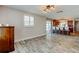 Open living room view to kitchen, hardwood floors, neutral paint, and natural light at 1041 Persimmon Dr, Palm Harbor, FL 34683