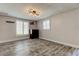 Bright living room with wood-look flooring, neutral paint, and plantation shutters at 1041 Persimmon Dr, Palm Harbor, FL 34683
