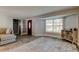 Bright living room with hardwood floors, large window, neutral walls and an interior door at 1041 Persimmon Dr, Palm Harbor, FL 34683