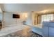 Light and bright living room features hardwood floors, large TV, and neutral wall color at 1041 Persimmon Dr, Palm Harbor, FL 34683
