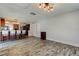 Spacious living room showcases wood-look floors, overhead lighting, and kitchen view at 1041 Persimmon Dr, Palm Harbor, FL 34683