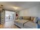 Living room with a large sectional sofa and sliding glass doors to a patio with a pool at 1041 Persimmon Dr, Palm Harbor, FL 34683