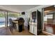 Outdoor kitchen with stainless steel refrigerator, counter bar, and a view of the pool at 1041 Persimmon Dr, Palm Harbor, FL 34683