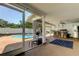 Outdoor patio with outdoor kitchen bar, a view of a pool, and screened in at 1041 Persimmon Dr, Palm Harbor, FL 34683