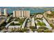 An aerial view of a neighborhood by the water with high-rise buildings and lush green landscaping at 1115 Rue Des Chateaux # 2B, South Pasadena, FL 33707