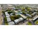 Aerial shot features complex with lush landscaping, pool, and ample parking in a neighborhood with surrounding businesses at 1115 Rue Des Chateaux # 2B, South Pasadena, FL 33707