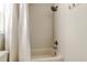 This bright bathroom features a shower-tub combination with a white shower curtain and tile surround at 1115 Rue Des Chateaux # 2B, South Pasadena, FL 33707