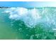 Scenic view of a powerful wave crashing onto a green colored beach, ocean view at 1115 Rue Des Chateaux # 2B, South Pasadena, FL 33707