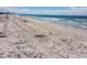 Beautiful beach view showing tire tracks in the sand leading to the water at 1115 Rue Des Chateaux # 2B, South Pasadena, FL 33707