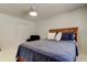 A bright bedroom features a woven headboard, fresh white walls, and a cozy blue bedspread at 1115 Rue Des Chateaux # 2B, South Pasadena, FL 33707