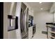 Modern kitchen boasts stainless steel refrigerator with water dispenser and modern appliances at 1115 Rue Des Chateaux # 2B, South Pasadena, FL 33707