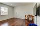 Bright living room with wood floors, dining table, television on the wall and natural light at 1115 Rue Des Chateaux # 2B, South Pasadena, FL 33707
