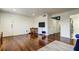 Bright living room features hardwood floors, dining area, and flat screen television on the wall at 1115 Rue Des Chateaux # 2B, South Pasadena, FL 33707