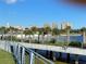 Scenic water view with a bridge, palm trees, and buildings in the distance at 1115 Rue Des Chateaux # 2B, South Pasadena, FL 33707