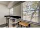 Wet bar area with white cabinetry, black granite countertops and a view outside at 1115 Rue Des Chateaux # 2B, South Pasadena, FL 33707
