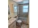 This bathroom features a shower over tub and a mirrored cabinet, offering convenience and functionality at 11206 Golden Ridge Dr, Seminole, FL 33772