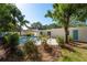 Large backyard with pool, patio, mature trees, and landscaping at 1152 Jackmar Rd, Dunedin, FL 34698