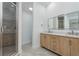 Bathroom featuring a walk-in shower and double vanity at 1152 Jackmar Rd, Dunedin, FL 34698