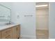Bathroom vanity with marble countertop and open closet with wire shelving at 1152 Jackmar Rd, Dunedin, FL 34698