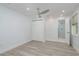 Bright bedroom with a ceiling fan, closet, and ensuite bathroom with glass shower at 1152 Jackmar Rd, Dunedin, FL 34698