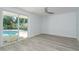 Bedroom with wood floors and sliding glass doors with pool view at 1152 Jackmar Rd, Dunedin, FL 34698