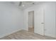 Neutral bedroom with recessed lighting, ceiling fan, new floors and an open door at 1152 Jackmar Rd, Dunedin, FL 34698