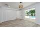 Light-filled bedroom with a sliding glass door leading to a pool and a view of the backyard at 1152 Jackmar Rd, Dunedin, FL 34698