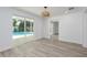 Bright bedroom with backyard pool view, light walls and floors, and neutral accents for a relaxing atmosphere at 1152 Jackmar Rd, Dunedin, FL 34698