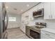 Well-equipped kitchen with stainless steel appliances, sleek countertops, and ample cabinet storage at 1152 Jackmar Rd, Dunedin, FL 34698