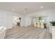 Open-concept living space with hardwood floors connecting the living room, dining area, and kitchen at 1152 Jackmar Rd, Dunedin, FL 34698