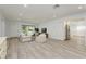 Inviting living room with ample natural light, comfortable seating, and stylish hardwood floors at 1152 Jackmar Rd, Dunedin, FL 34698