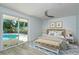 Comfortable main bedroom with a view of the pool, soft decor, and a ceiling fan at 1152 Jackmar Rd, Dunedin, FL 34698