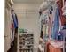 Organized walk-in closet with shelves and hanging racks for clothing and shoes at 11665 Leisure W Ln, Largo, FL 33773