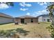Home's backyard shows the rear facade and a small, manicured lawn area at 11707 Sunburst Marble Rd, Riverview, FL 33579