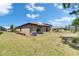 Lawn featuring an AC unit and a covered back patio that opens to the house with sliding glass doors at 11707 Sunburst Marble Rd, Riverview, FL 33579