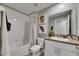 A bathroom featuring a shower-tub combo and modern granite vanity at 11707 Sunburst Marble Rd, Riverview, FL 33579