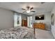 This bedroom offers a ceiling fan, and natural light from the large window at 11707 Sunburst Marble Rd, Riverview, FL 33579