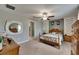 This bedroom has a ceiling fan, mirror, and a neutral color palette at 11707 Sunburst Marble Rd, Riverview, FL 33579