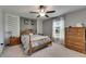 Bedroom featuring stylish wall accents, ceiling fan and ample natural light at 11707 Sunburst Marble Rd, Riverview, FL 33579