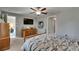 This bedroom features a ceiling fan, TV, and an antique wood dresser at 11707 Sunburst Marble Rd, Riverview, FL 33579