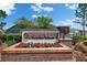 Stone Walk community entrance sign features brick, flowers, and manicured landscaping against a sunny sky at 11707 Sunburst Marble Rd, Riverview, FL 33579