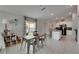 Open dining area adjacent to the kitchen with modern table and chairs plus a kitchen island at 11707 Sunburst Marble Rd, Riverview, FL 33579