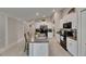 Bright, spacious kitchen featuring white cabinets, black appliances, granite countertops and tile flooring at 11707 Sunburst Marble Rd, Riverview, FL 33579