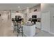Spacious kitchen with an island offering bar seating, white cabinets, and black appliances at 11707 Sunburst Marble Rd, Riverview, FL 33579