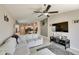 Open-concept living room featuring neutral tones, a large TV, and modern furnishings at 11707 Sunburst Marble Rd, Riverview, FL 33579