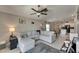 Cozy living room with a comfortable sectional sofa, ceiling fan, and open view into the kitchen at 11707 Sunburst Marble Rd, Riverview, FL 33579
