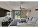 Living room with plush gray rug, contemporary furniture, and sliding glass door to backyard views at 11707 Sunburst Marble Rd, Riverview, FL 33579