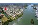 A scenic aerial view of a neighborhood along the water with a boat dock, indicated by a red arrow at 14921 Crown Dr, Largo, FL 33774