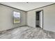 The bedroom offers a large window and wood-look flooring at 16137 Melbourne St, Brooksville, FL 34604